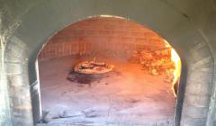 This black oven is a traditional wood burning pizza oven.